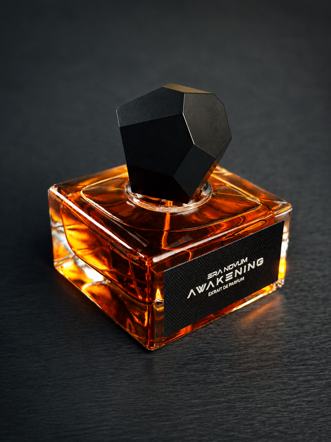 Perfume bottle labeled 'Awakening' on a dark background